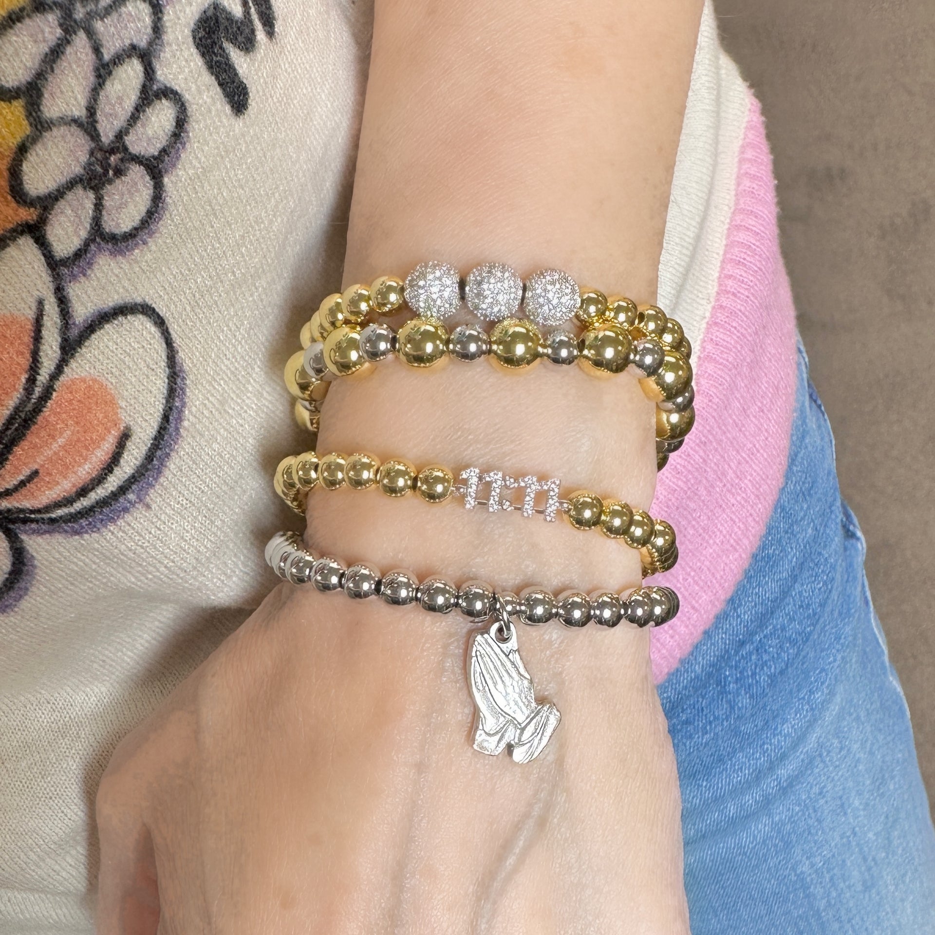 Stacked 11 11 bracelet worn on wrist with other styles