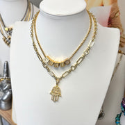 Hailey hamsa necklace on a white display