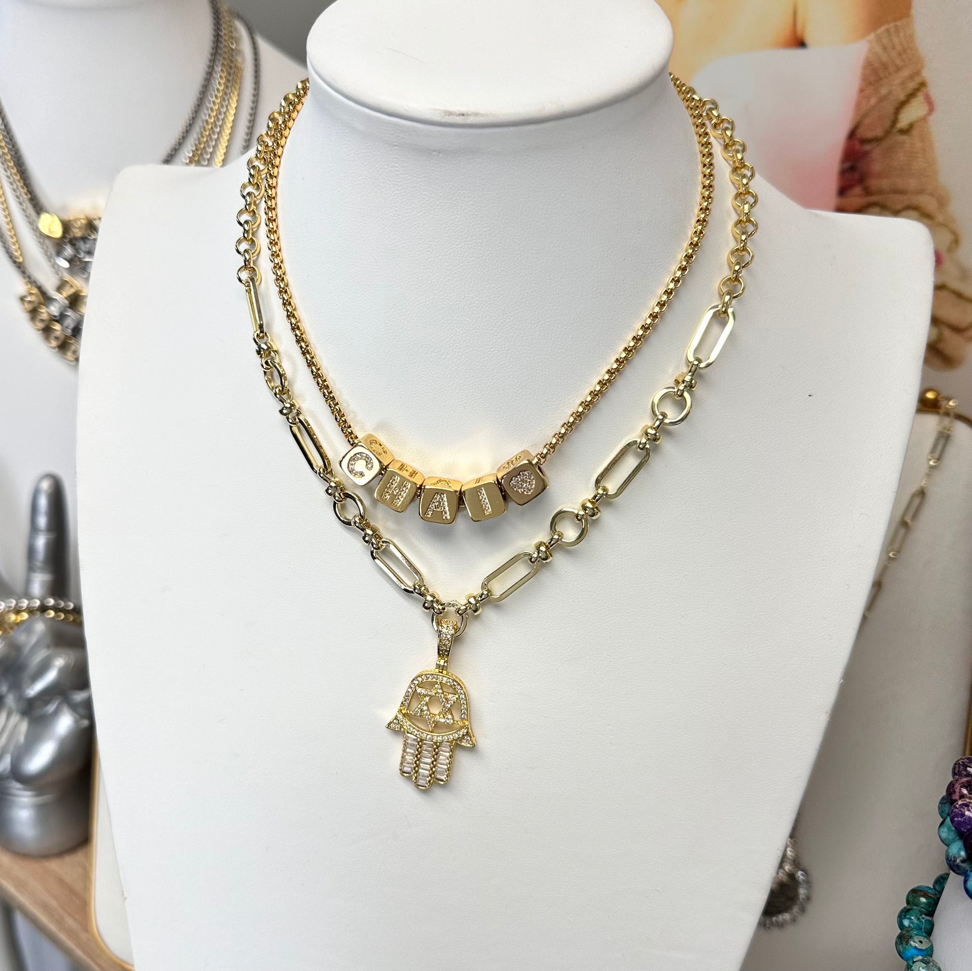 Hailey hamsa necklace on a white display