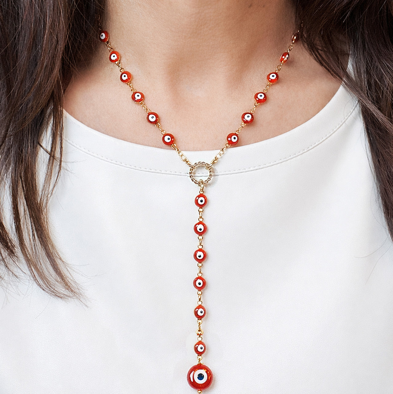  Love Lisa lucia evil eye y necklace in gold red worn showing drop silhouette and beaded evil eye chain