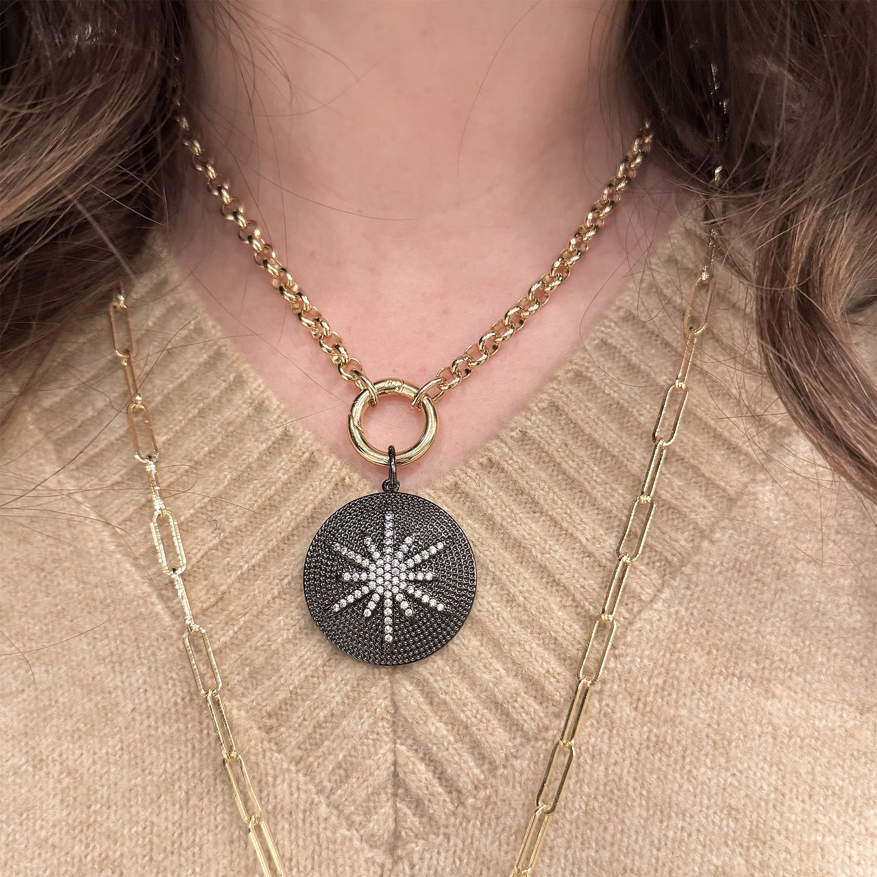 Nova Luxe Gunmetal Pendant styled with layered gold necklaces