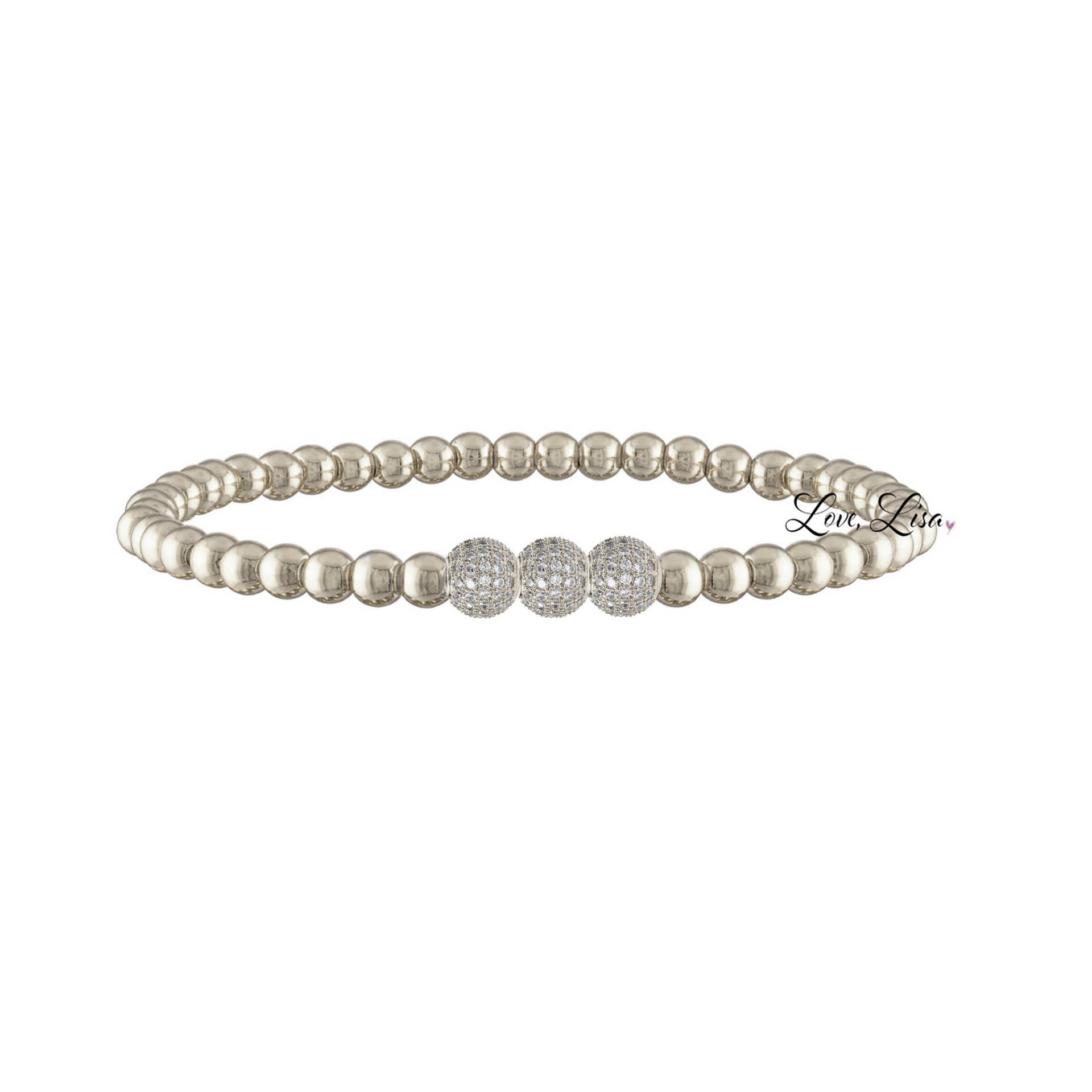 A gold bracelet stack featuring a series of round beads and a heart-shaped charm.