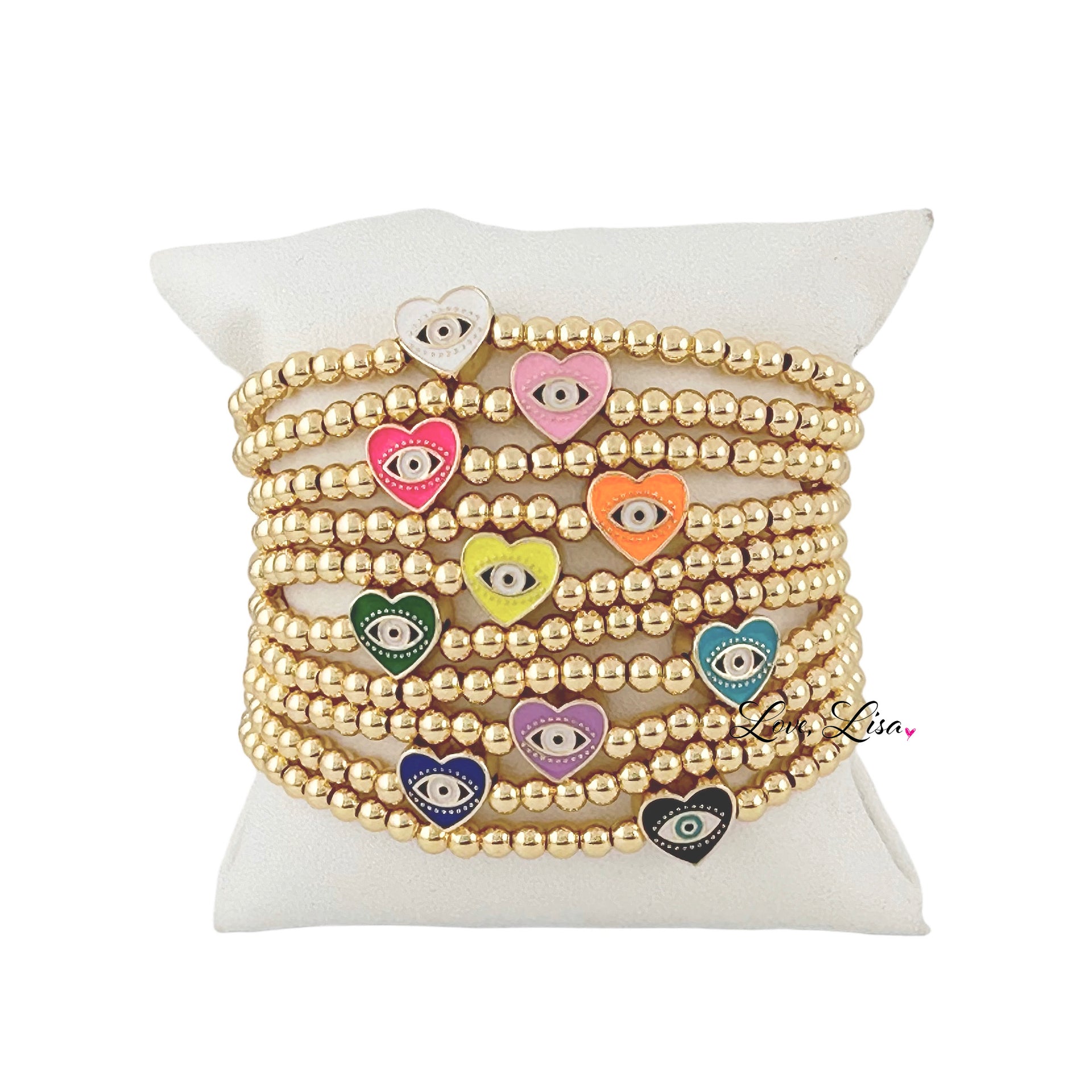 A collection of beaded bracelets with gold-colored beads and multicolored heart charms displayed on a white surface.