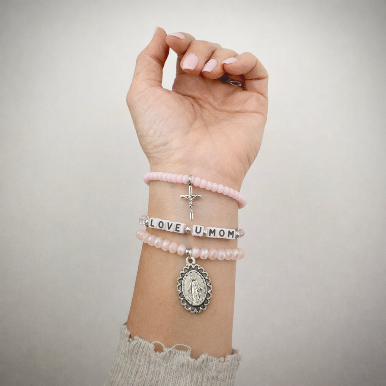 Love Lisa abigail love you mom faith bracelet stack worn stacked bracelets showing cross and miraculous medal charms
