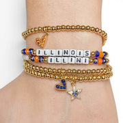 Stack of gold and colorful beaded bracelets on a wrist with 'ILLINOIS' bracelet.