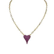 A gold-colored necklace with a paperclip chain and a heart-shaped pendant with pink crystals.