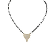A gunmetal colored necklace with a paperclip chain and a heart-shaped pendant with gold crystals.
