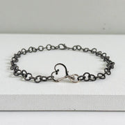 Alessia Heart Clasp Necklace styled on a box