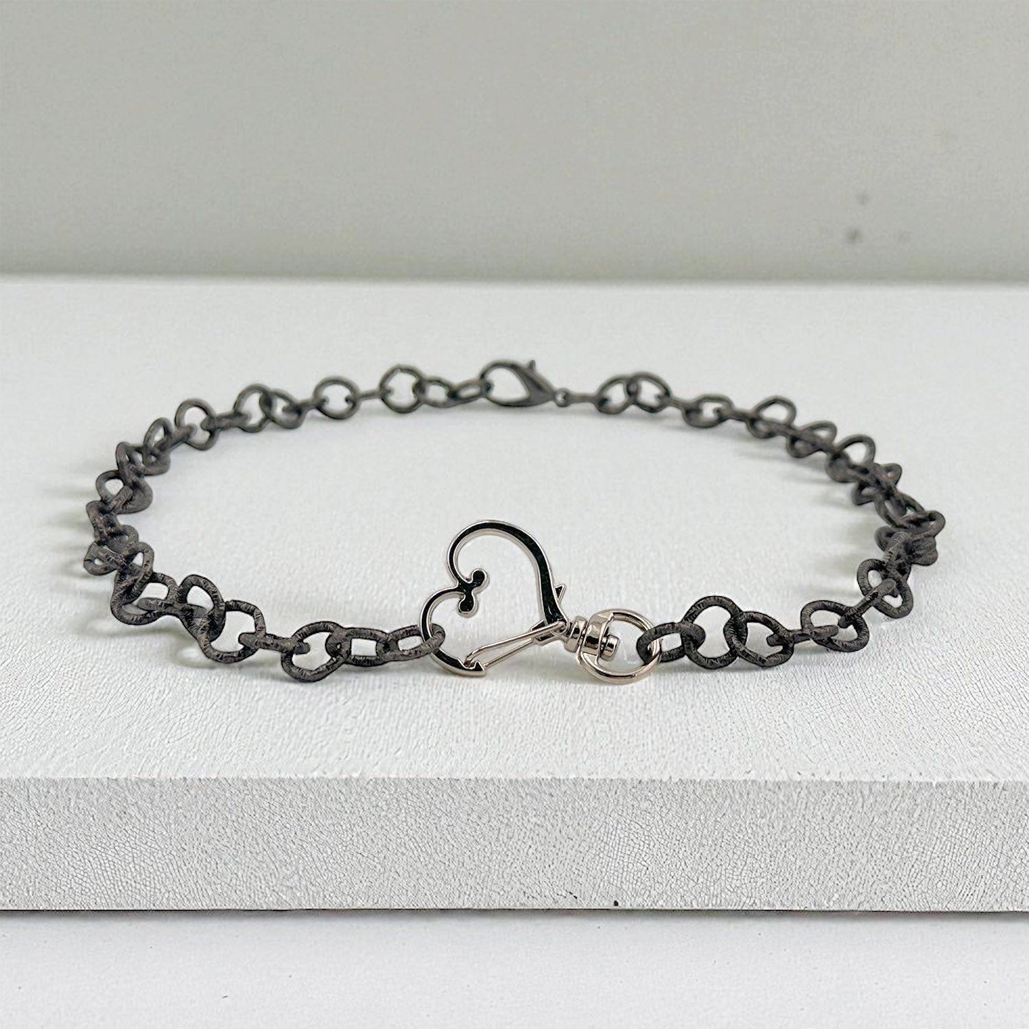 Alessia Heart Clasp Necklace styled on a box