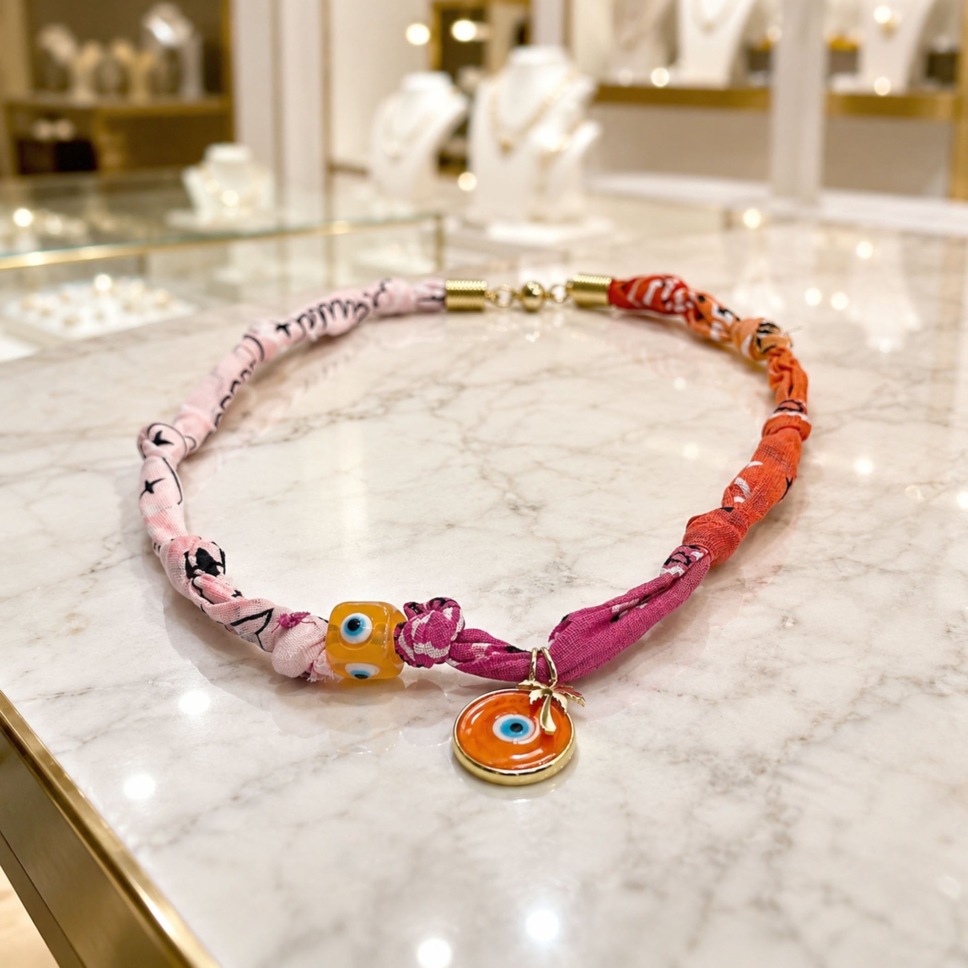 Love Lisa Amalfi talisman bandana necklaces shown in colorful fabric styles with evil eye beads and gold charms