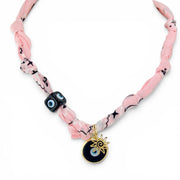 Santorini sun talisman bandana necklace with soft pink fabric evil eye beads and gold sun charm
