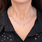 Close-up of Amanda Heart Chain Necklace in silver worn on neck, featuring sparkling crystal stations and heart link detail