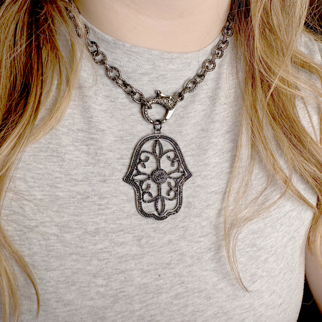 Amani Luxe Hamsa Pendant by Love Lisa layered on clasp necklace