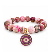 Amara Evil Eye Gemstone Bracelet with faceted pink gemstone beads, round pink crystal evil eye charm, and gold-tone details