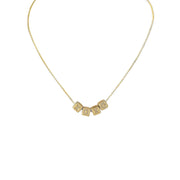A personalized necklace with gold chain and silver block letter beads.