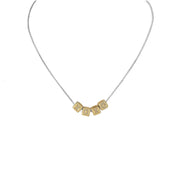 A personalized necklace with gold chain and silver block letter beads.