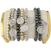 A collection of beaded bracelets with various metallic finishes and Saint medals.