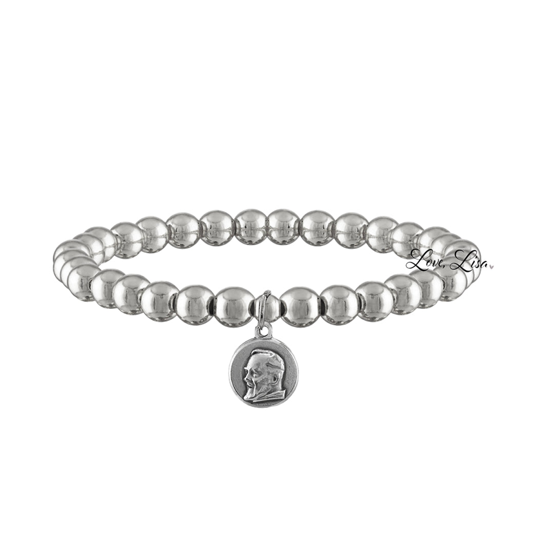 A collection of beaded bracelets with various metallic finishes and Saint medals.