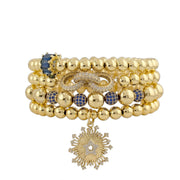 Set of gold beaded bracelets with blue accents and a star-shaped pendant on a white background