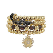 Aurora Star gold bracelet stack with brown and black beads