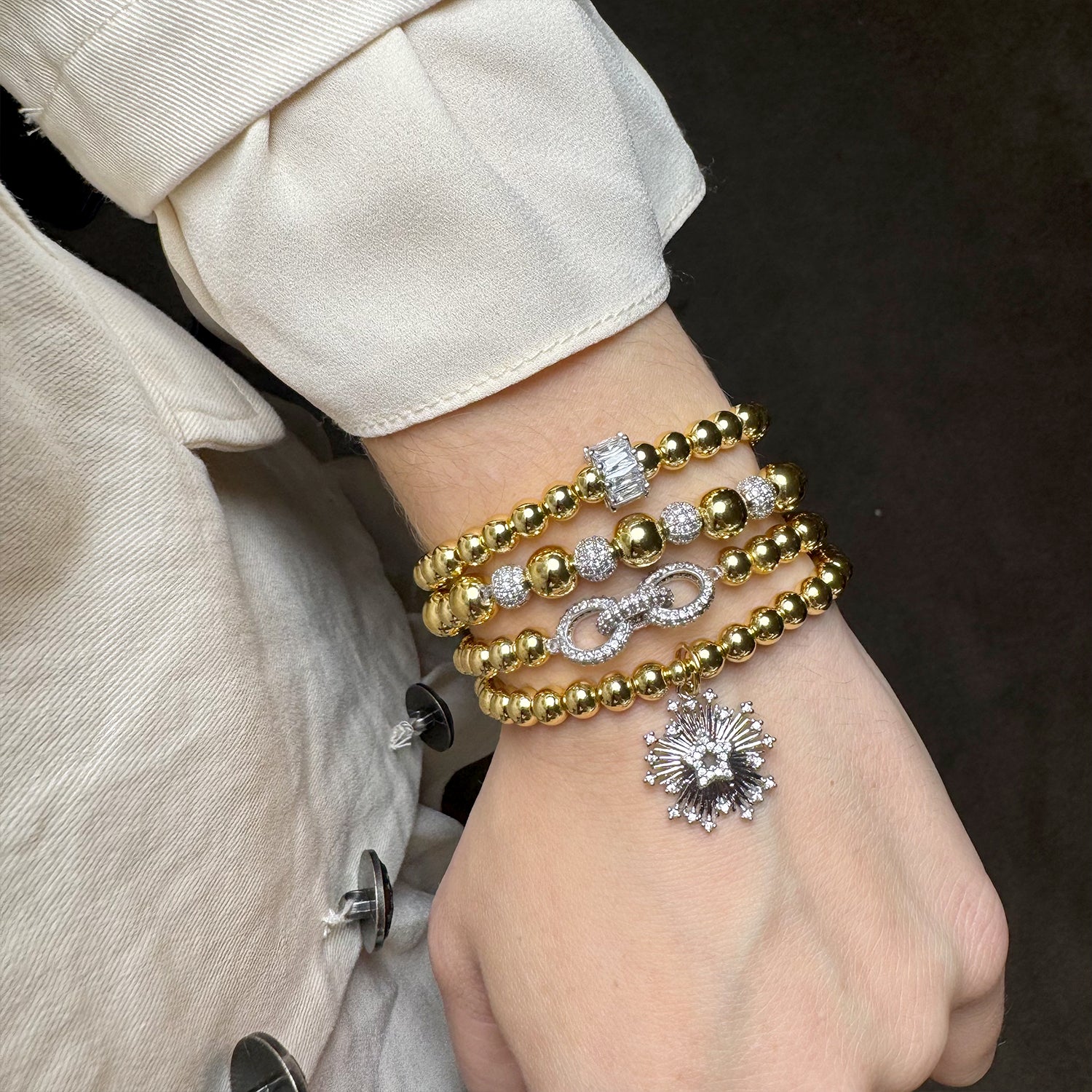 Love Lisa Aurora Star gold bracelet stack on wrist with star charm