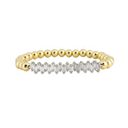 A gold-colored bracelet with round beads and baguette accents, designed to resemble a diamond bracelet.