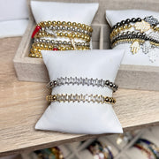 baguette stretch beaded bracelet displayed on pillow layered with other styles love lisa