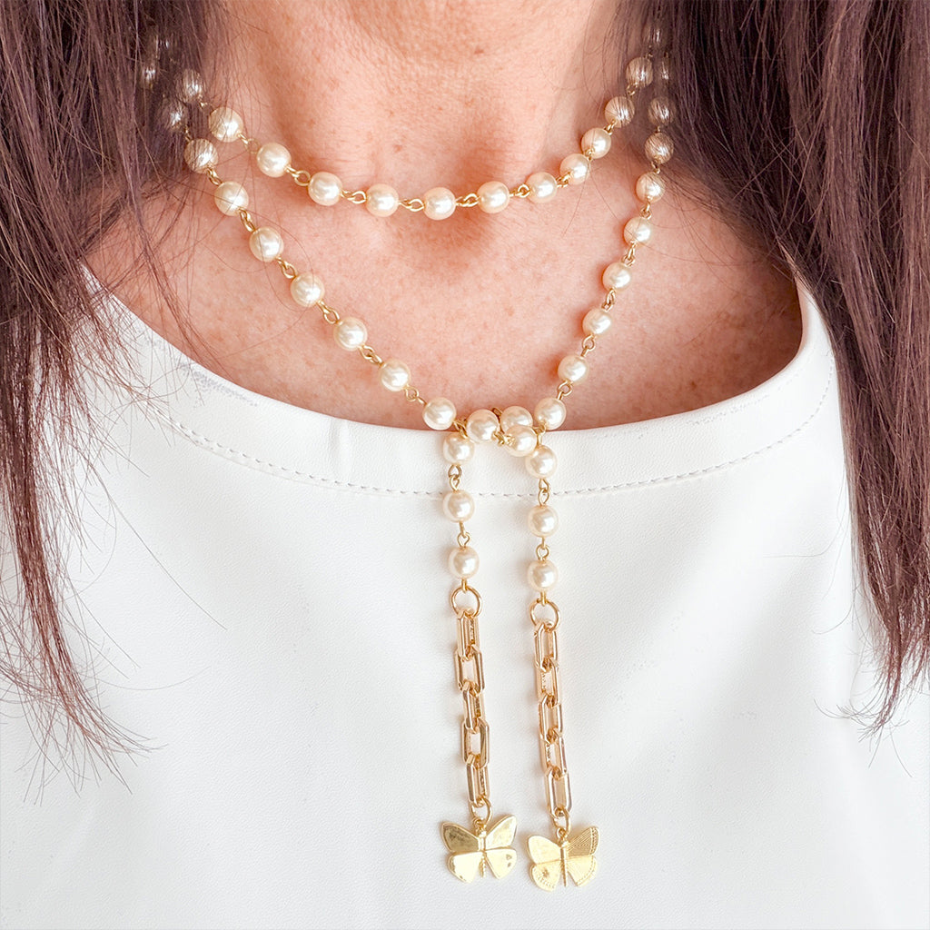 Love Lisa bailey butterfly wrap lariat necklace in pearl gold worn showing layered wrap and drop detail at neckline
