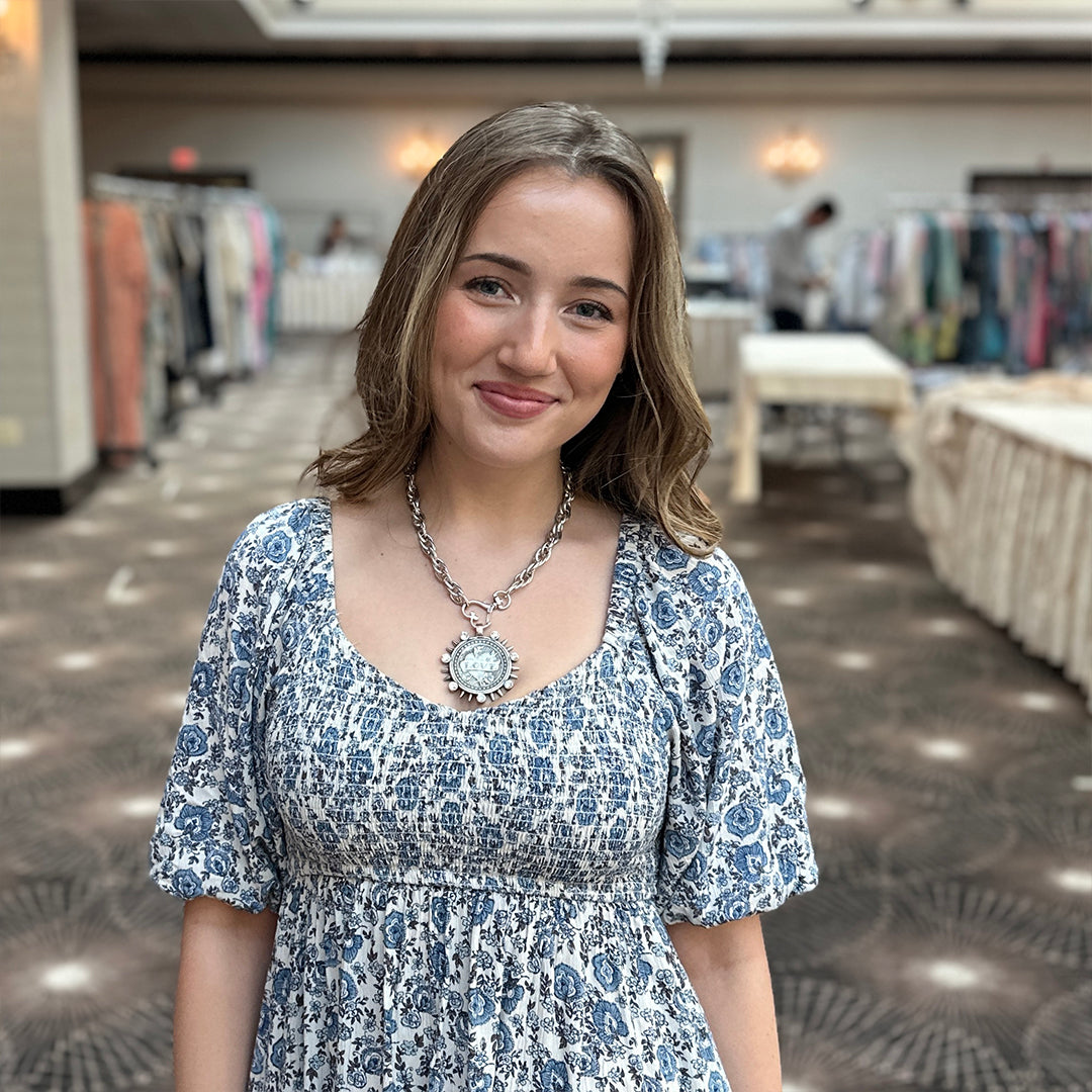 Model wearing Bari Coin Necklace with LOVE medallion crystal sunburst and heart clasp by Love Lisa