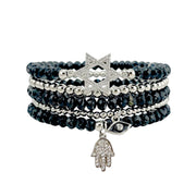 Beautiful Jewish star stack of bracelets featuring a pavé Star of David hamsa charm and evil eye accents in silver and black tones
