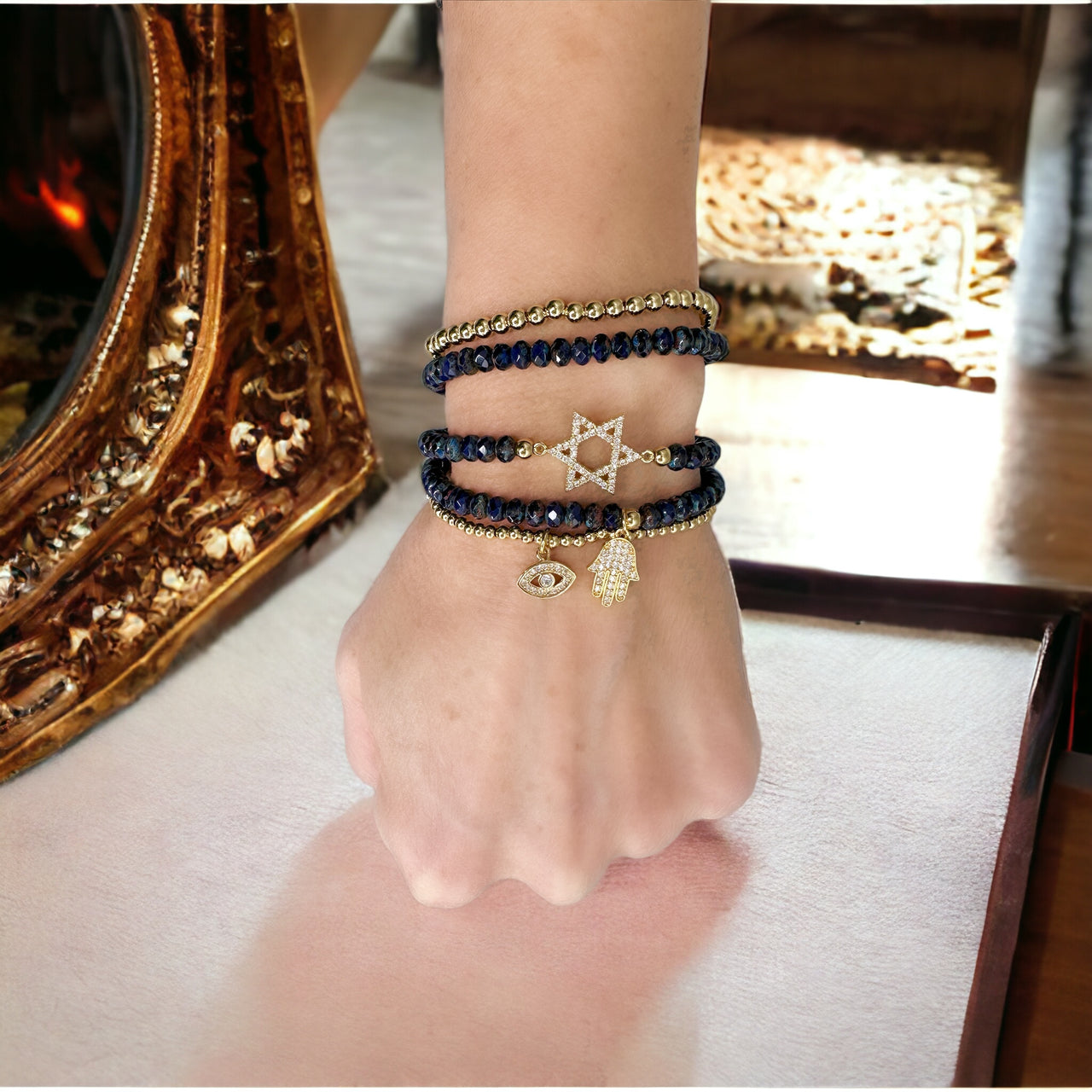 beautiful jewish star stack of bracelets navy and gold worn on wrist layered religious charm bracelets by love lisa