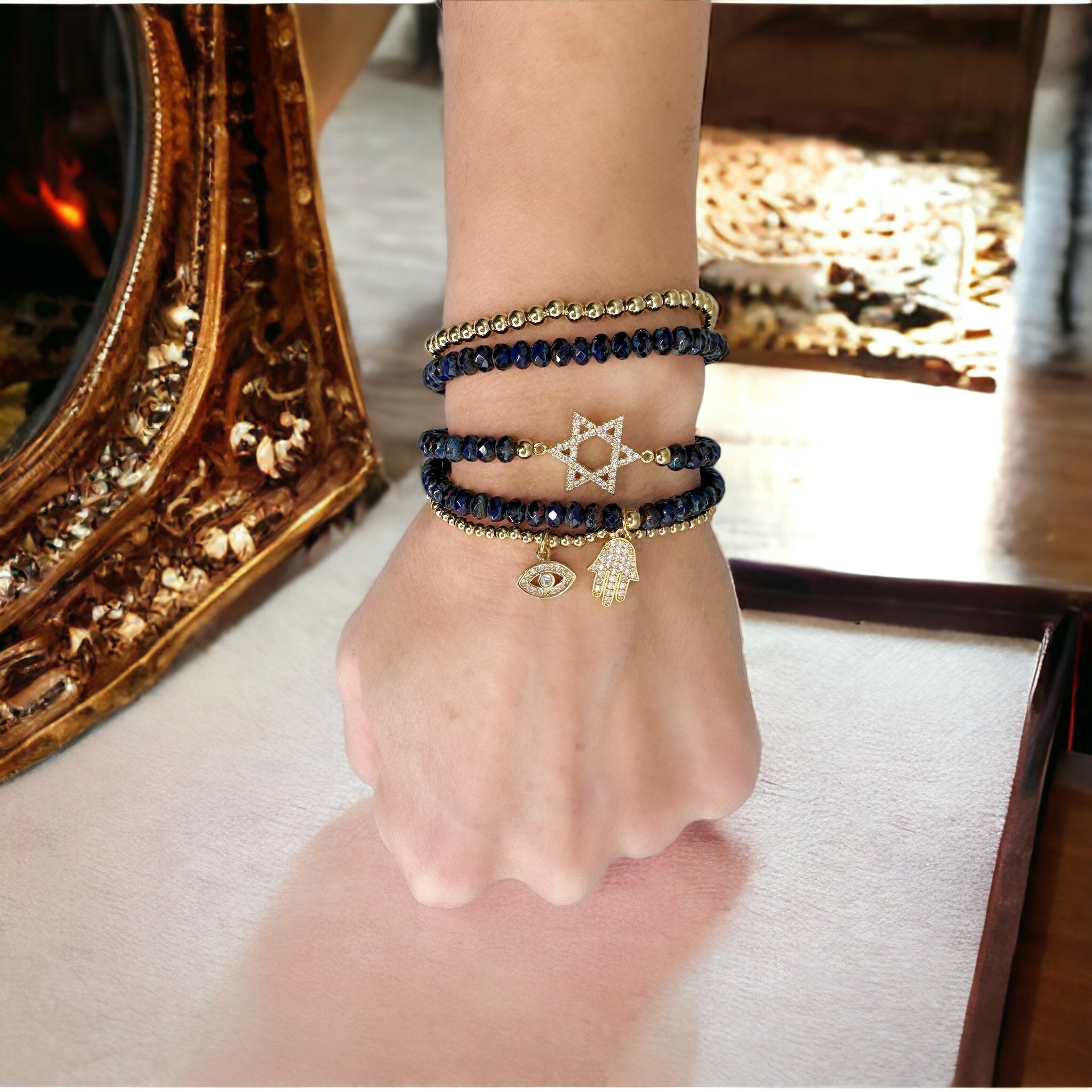 beautiful jewish star stack of bracelets navy and gold worn on wrist layered religious charm bracelets by love lisa