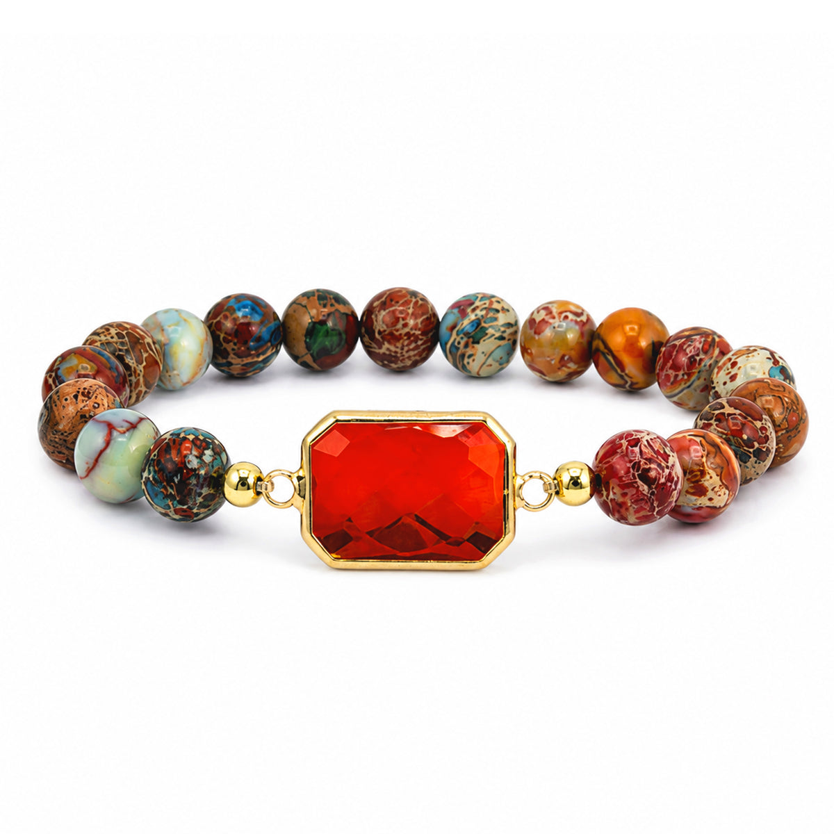 A beaded stretch bracelet featuring a central faceted red gemstone in a gold bezel setting, flanked by multiple round marbled beads in earthy red, brown, gold, and blue tones, set against a plain white background.