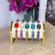 Love Lisa Bellissima Emerald Cut Crystal Gemstone Bracelets displayed in Red, Green, Pink, Purple, and Teal colorways