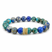 A beaded stretch bracelet featuring round blue and green marbled beads with natural gold veining, accented by a central gold-toned ring with small clear stones, shown on a plain white background.