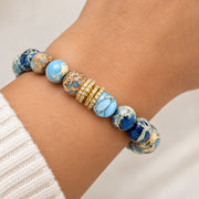 Love Lisa Bellissima Luxe Bracelet worn on wrist with blue Sea Sediment Jasper beads and a sparkling pavé crystal rondelle centerpiece