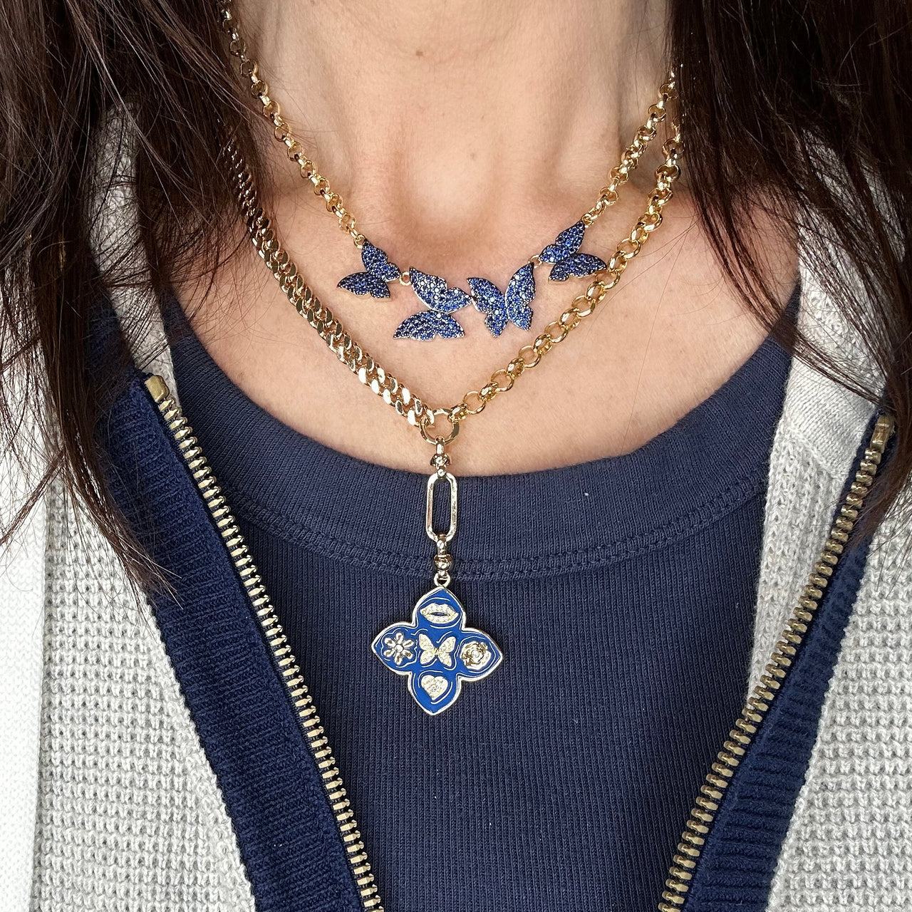 betty butterfly necklace on a model in blue pave crystals