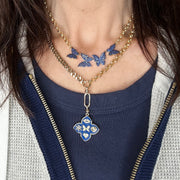 betty butterfly necklace on a model in blue pave crystals