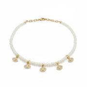 Bianca Mother of Pearl Evil Eye Necklace flat lay showing five pavé evil eye charms and mother of pearl beads