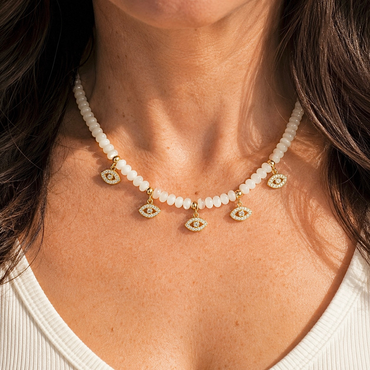 Love Lisa Bianca Mother of Pearl Evil Eye Necklace worn on neck with layered gold protection jewelry styling