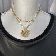 brandy long bow necklace gold cz bow pendant layered with other chains by love lisa jewelry