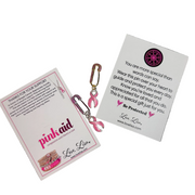 Love Lisa Breast Cancer Awareness Pink Ribbon Safety Pin packaging with message card, pink ribbon charm, and Pink Aid logo