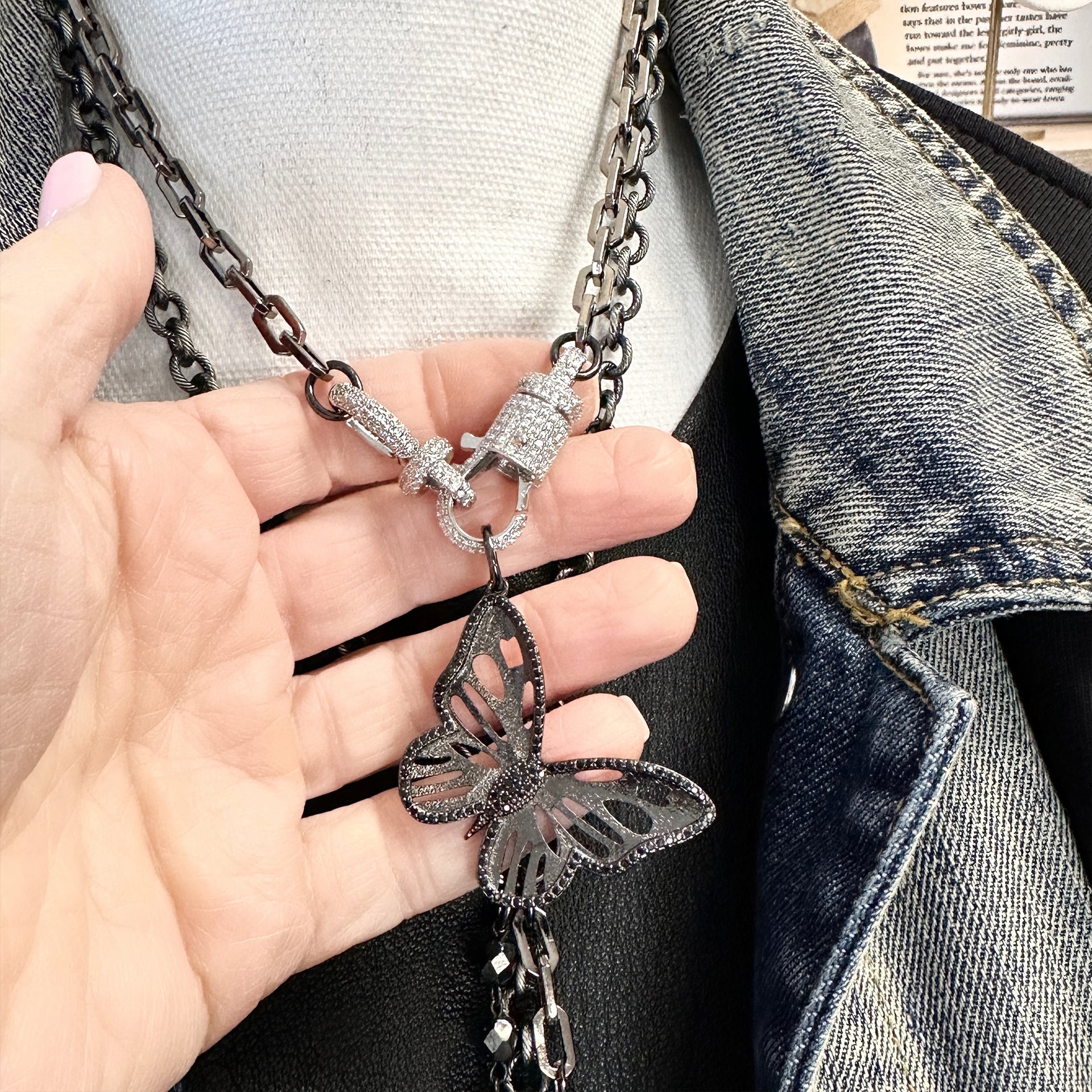 Brianna’s Butterfly Charm shown in hand for scale