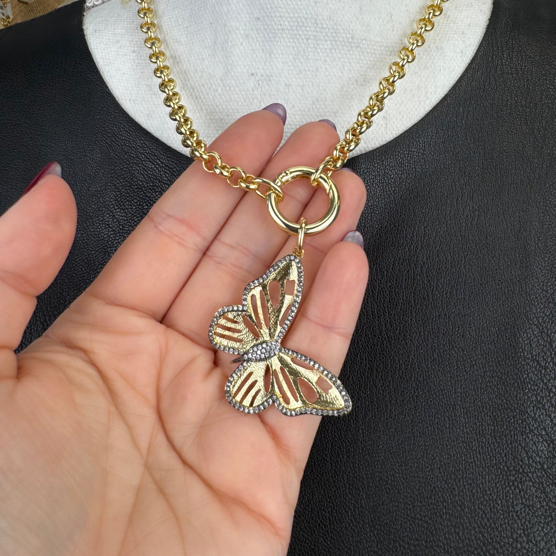 Brianna’s Butterfly Charm shown in hand for scale