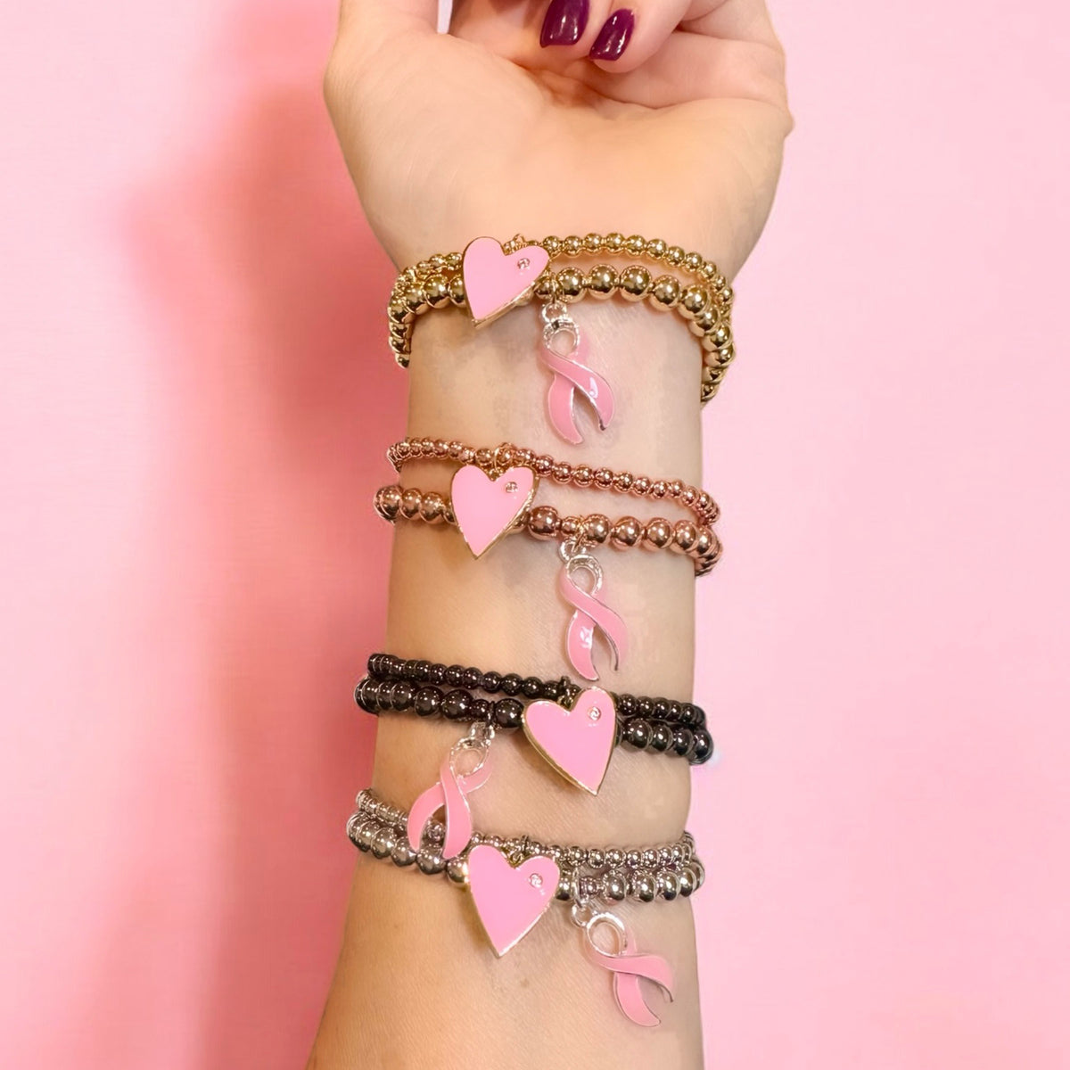 Love Lisa Camille Breast Cancer Awareness Pink Ribbon Bracelet worn in a bracelet stack with polished metal beads and pink ribbon charm