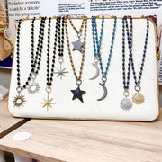 Display of celestial beaded necklaces with sun moon and star pendants