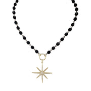 Flat lay of gold north star beaded necklace