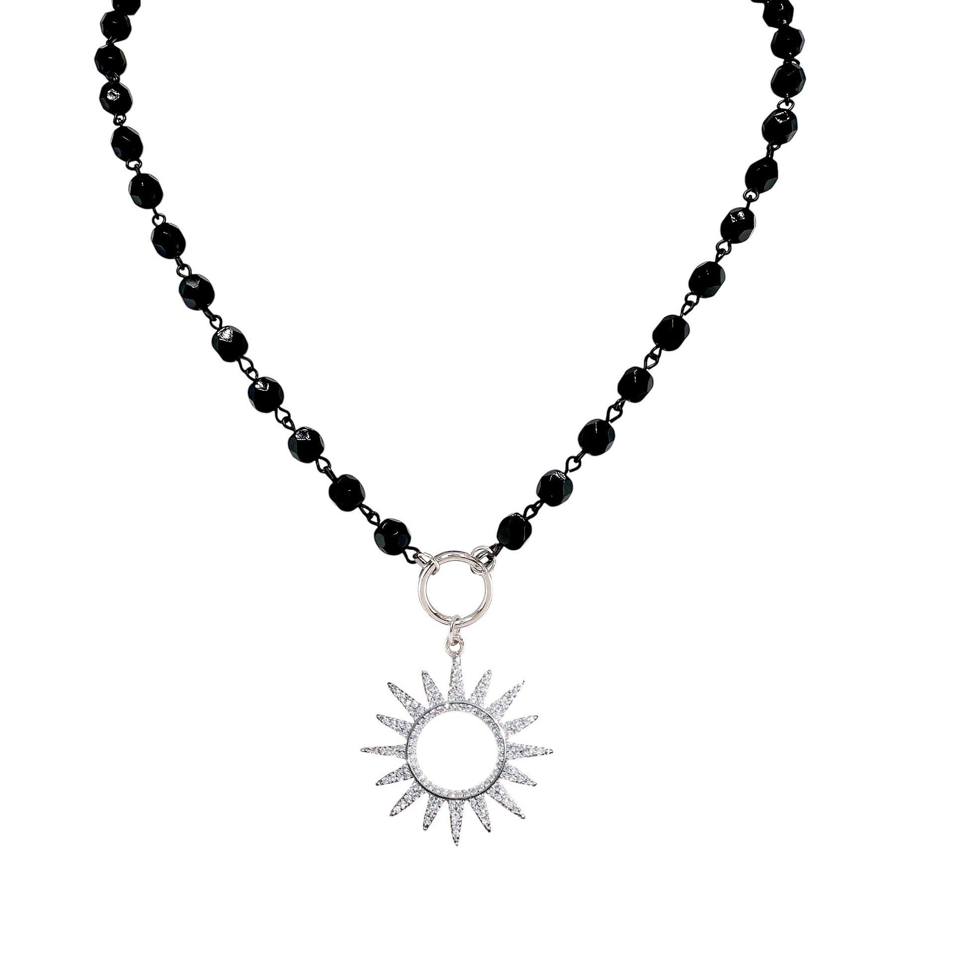Flatlay of silver sun beaded necklace on black beads