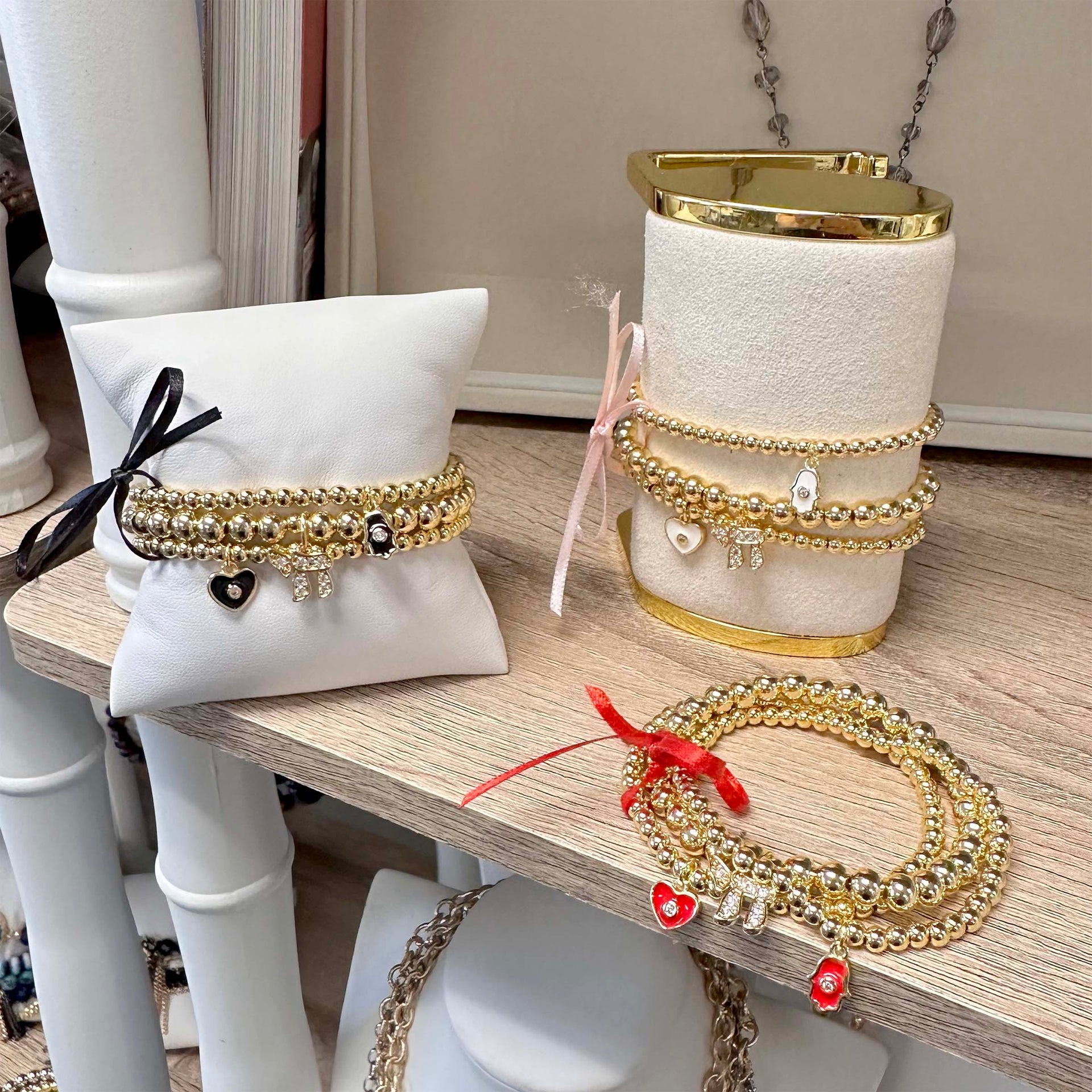 Love Lisa chai evil eye hamsa charm bracelet stack with enamel charms on displays 