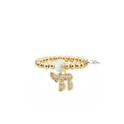 Love Lisa Noa Luxe Chai Stretch Ring in gold with polished 3mm beads pavé Chai charm and white bead accent